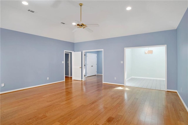 spare room with ceiling fan and light wood-type flooring