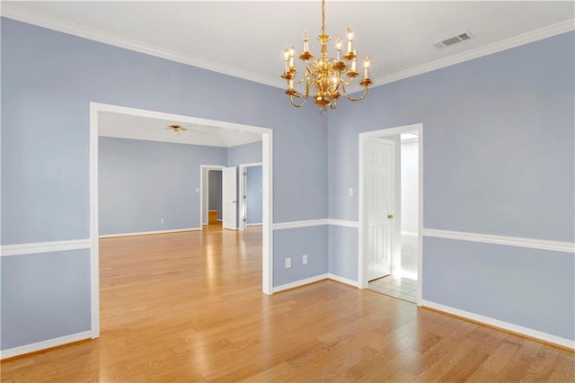 empty room with ornamental molding, light hardwood / wood-style flooring, and ceiling fan with notable chandelier