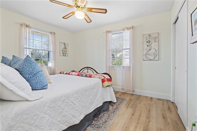 bedroom featuring light hardwood / wood-style floors, a closet, and ceiling fan