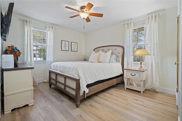 bedroom with ceiling fan and light wood-type flooring