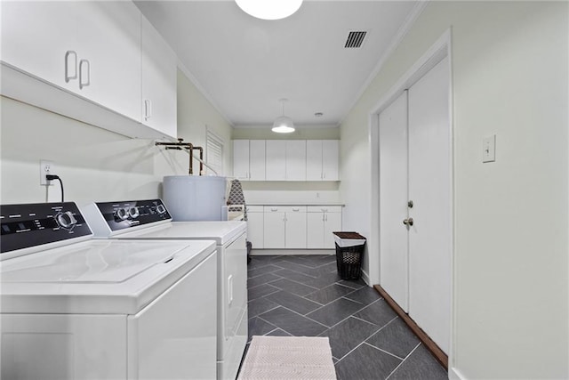 laundry area with water heater, crown molding, separate washer and dryer, and cabinets