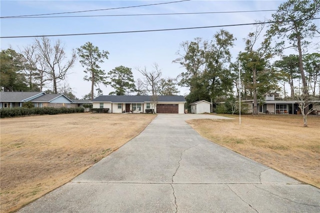 single story home with a garage and a front yard