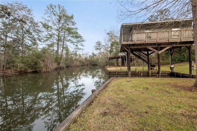 dock area with a lawn and a water view