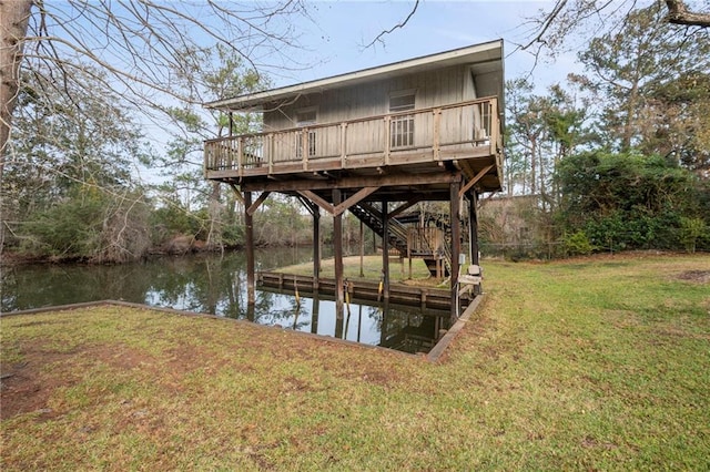 dock area with a lawn and a water view