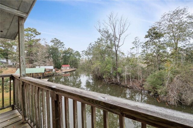 wooden terrace featuring a water view