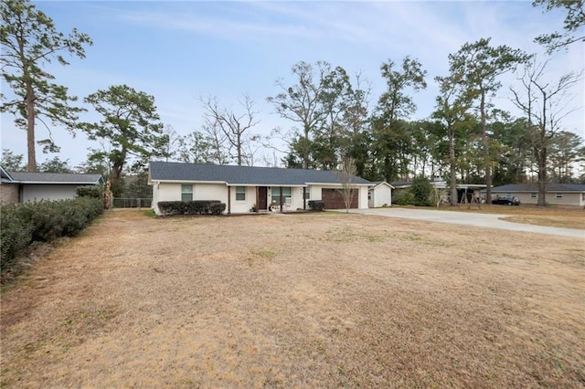 ranch-style home featuring a garage and a front yard