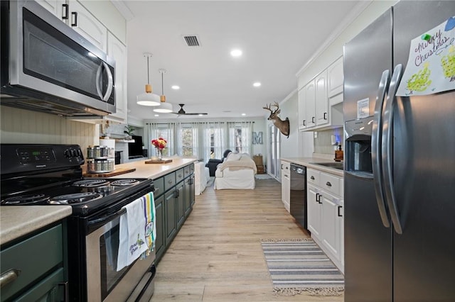 kitchen with crown molding, light hardwood / wood-style flooring, ceiling fan, white cabinetry, and stainless steel appliances