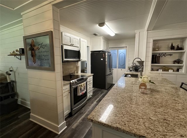 2911 Thornhill Dr, Mobile, AL 36606 - kitchen featuring appliances with stainless steel finishes, dark wood finished floors, and light stone countertops