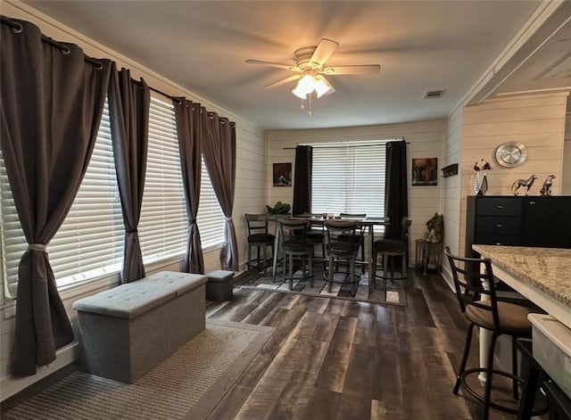 2911 Thornhill Dr, Mobile, AL 36606 - dining room featuring ceiling fan, dark wood finished floors, and wood walls