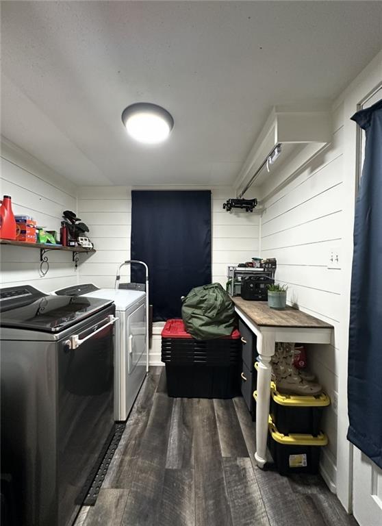 2911 Thornhill Dr, Mobile, AL 36606 - laundry room with washing machine and clothes dryer, dark wood-style floors, and wooden walls
