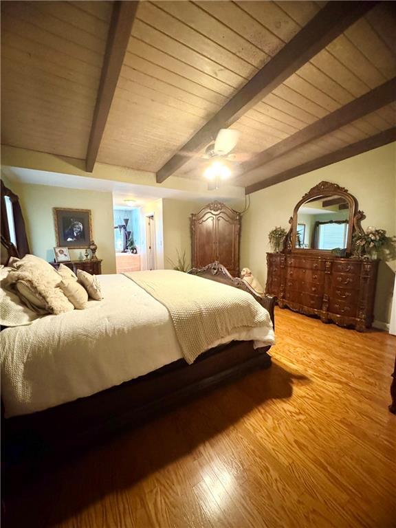 14522 St Stephens Ave, Chatom, AL 36518 - bedroom with wood ceiling, beamed ceiling, and light wood-type flooring