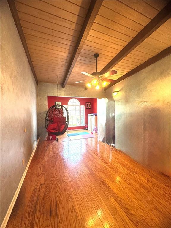 14522 St Stephens Ave, Chatom, AL 36518 - unfurnished room featuring beamed ceiling, wood ceiling, wood finished floors, and ceiling fan