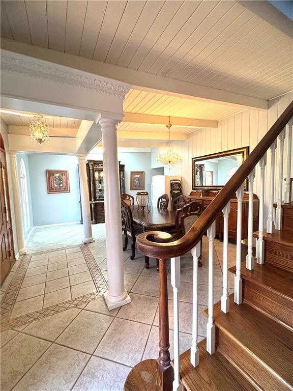 14522 St Stephens Ave, Chatom, AL 36518 - interior space featuring tile patterned floors, decorative columns, a notable chandelier, beamed ceiling, and wooden ceiling