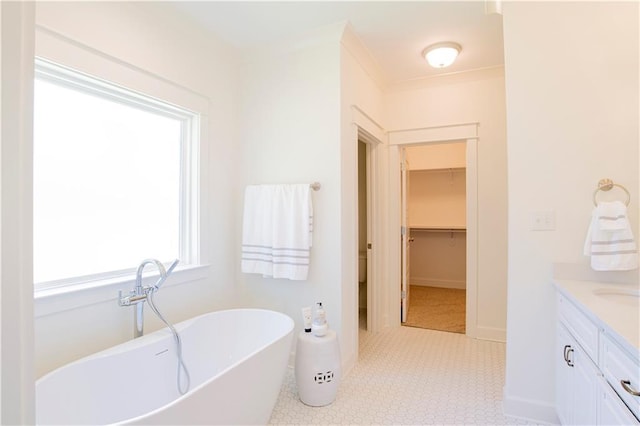 305 Hannah Chase Way, Satsuma, AL 36572 - bathroom featuring a freestanding bath, vanity, baseboards, and tile patterned floors