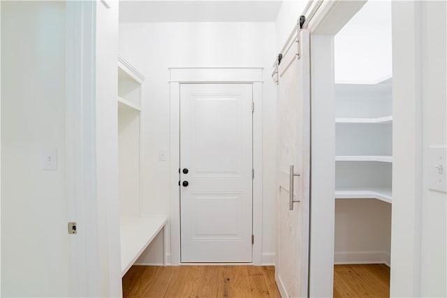 305 Hannah Chase Way, Satsuma, AL 36572 - mudroom featuring light wood-style flooring, a barn door, and baseboards