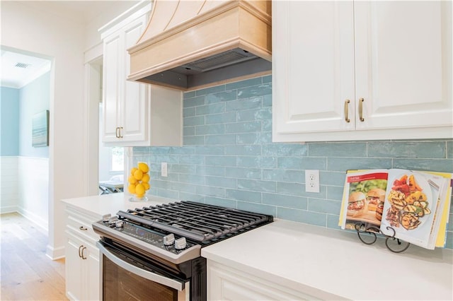 305 Hannah Chase Way, Satsuma, AL 36572 - kitchen with stainless steel gas range, custom range hood, light wood-style floors, light countertops, and a wainscoted wall