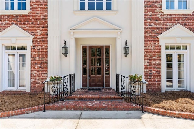 view of exterior entry with brick siding