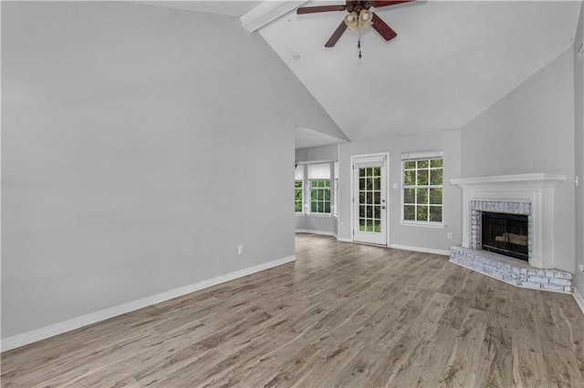 13163 Buckthorn Ct, Mobile, AL 36608 - unfurnished living room with a ceiling fan, a brick fireplace, wood finished floors, beam ceiling, and high vaulted ceiling