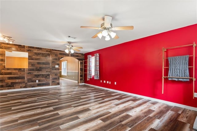 empty room with dark hardwood / wood-style floors and ceiling fan