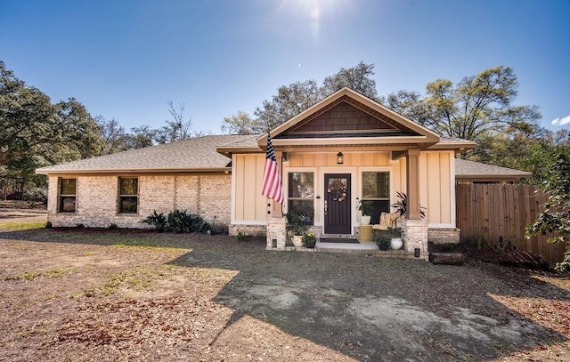 7420 Pake Rd, Saraland, AL 36571 - view of front facade featuring board and batten siding, brick siding, and fence