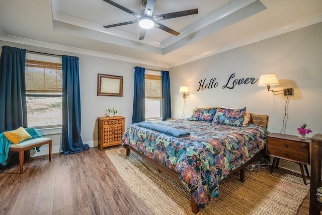 7420 Pake Rd, Saraland, AL 36571 - bedroom featuring crown molding, a tray ceiling, multiple windows, and wood finished floors