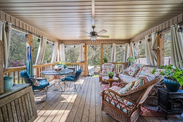 7420 Pake Rd, Saraland, AL 36571 - sunroom with outdoor lounge area, a wood stove, and a ceiling fan