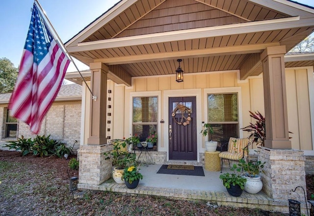 7420 Pake Rd, Saraland, AL 36571 - view of exterior entry featuring board and batten siding and a porch