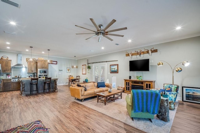 7420 Pake Rd, Saraland, AL 36571 - living room with crown molding, a ceiling fan, visible vents, and light wood-type flooring