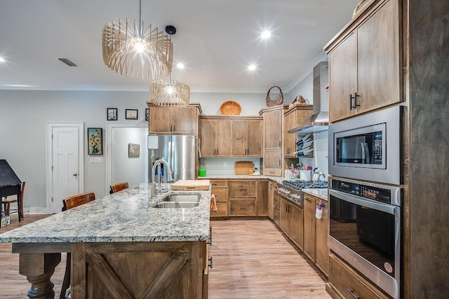 7420 Pake Rd, Saraland, AL 36571 - kitchen featuring crown molding, a sink, light wood finished floors, wall chimney exhaust hood, and appliances with stainless steel finishes