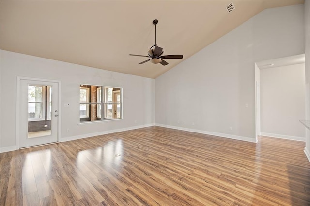 empty room with ceiling fan, light hardwood / wood-style flooring, and high vaulted ceiling