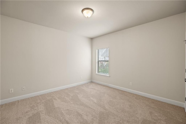 unfurnished room featuring light colored carpet