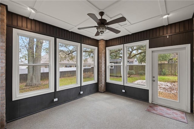 unfurnished sunroom with plenty of natural light and ceiling fan