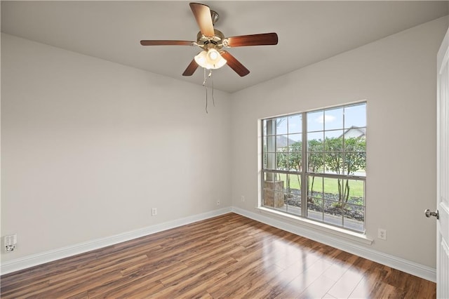 spare room featuring ceiling fan and dark hardwood / wood-style flooring