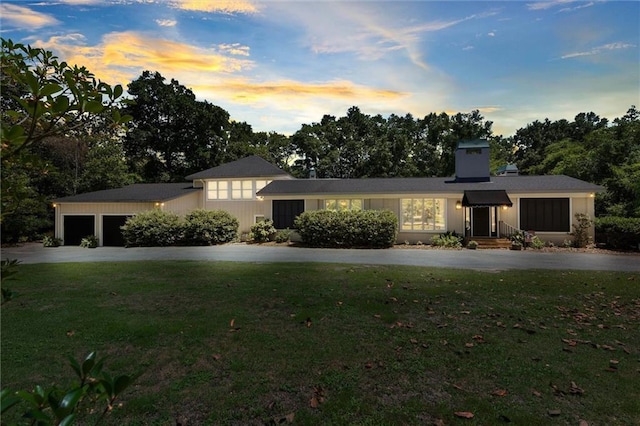 65 Byrnes Blvd, Mobile, AL 36608 - view of front of house featuring a yard, driveway, an attached garage, and a chimney