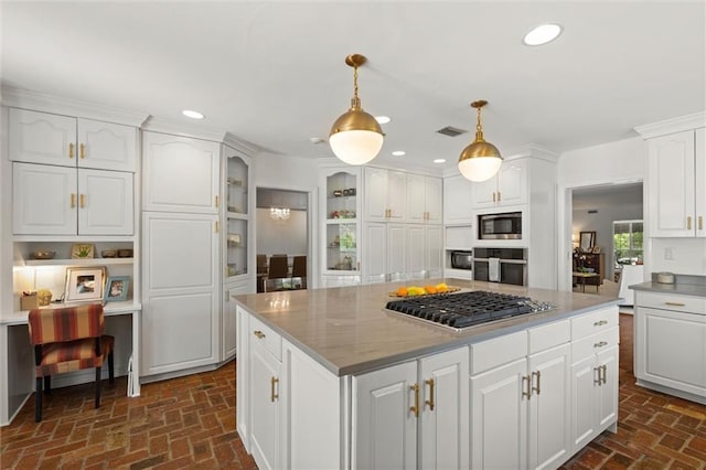 65 Byrnes Blvd, Mobile, AL 36608 - kitchen with appliances with stainless steel finishes, brick floors, white cabinets, recessed lighting, and a kitchen island
