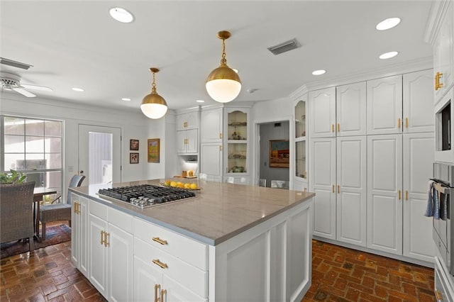 65 Byrnes Blvd, Mobile, AL 36608 - kitchen featuring stainless steel appliances, brick flooring, white cabinetry, hanging light fixtures, and recessed lighting