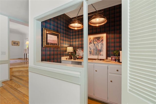 65 Byrnes Blvd, Mobile, AL 36608 - bar with wallpapered walls, an accent wall, a sink, and light wood-type flooring