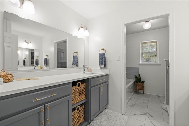 65 Byrnes Blvd, Mobile, AL 36608 - bathroom featuring marble finish flooring, vanity, a garden tub, and baseboards
