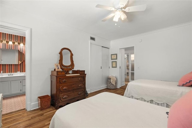 65 Byrnes Blvd, Mobile, AL 36608 - bedroom featuring wood finished floors, ornamental molding, a closet, ensuite bath, and a ceiling fan