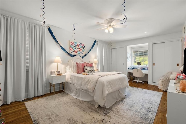 65 Byrnes Blvd, Mobile, AL 36608 - bedroom featuring multiple closets, a desk, wood finished floors, and ceiling fan