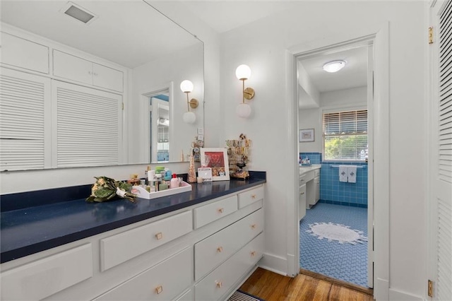 65 Byrnes Blvd, Mobile, AL 36608 - bathroom with vanity, wood finished floors, and tile walls