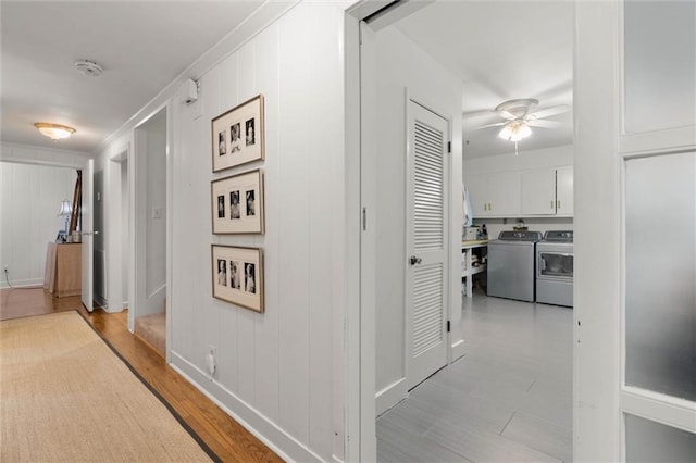 65 Byrnes Blvd, Mobile, AL 36608 - corridor with washer and clothes dryer, light wood-type flooring, a decorative wall, crown molding, and baseboards