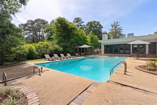 65 Byrnes Blvd, Mobile, AL 36608 - swimming pool featuring a patio area and view of wooded area