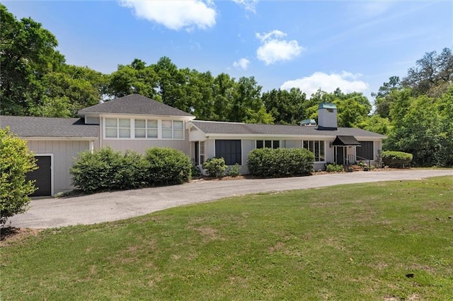 65 Byrnes Blvd, Mobile, AL 36608 - tri-level home with a front yard, driveway, and a chimney