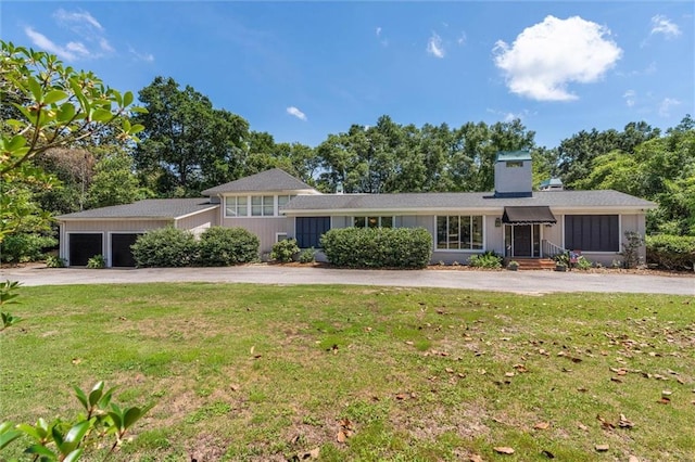 65 Byrnes Blvd, Mobile, AL 36608 - view of front of property featuring asphalt driveway, a front lawn, a chimney, an attached garage, and view of wooded area