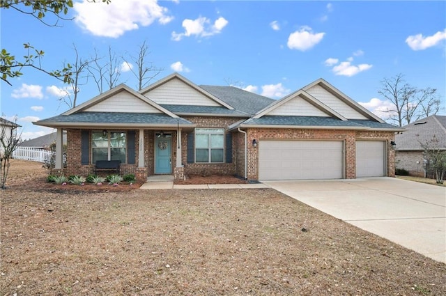 craftsman inspired home with a garage and covered porch