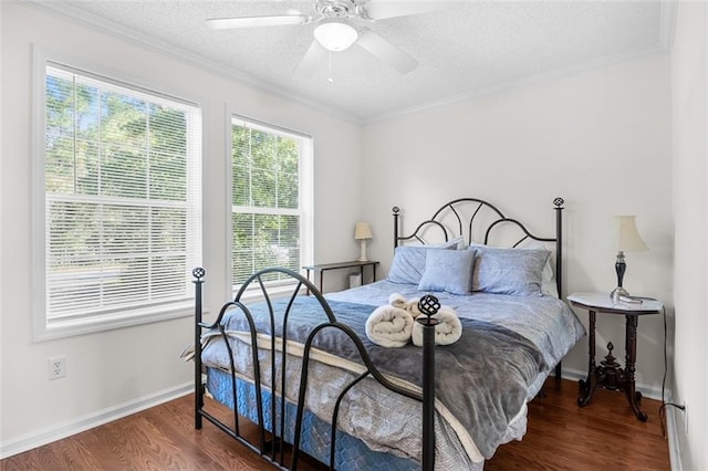 bedroom with ceiling fan, ornamental molding, a textured ceiling, and hardwood / wood-style floors