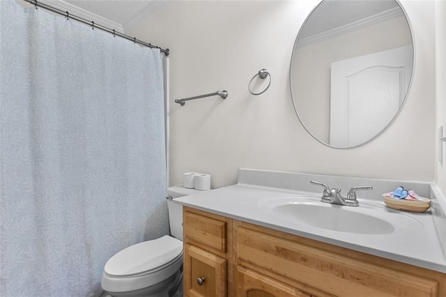 bathroom with a textured ceiling, crown molding, vanity, and toilet