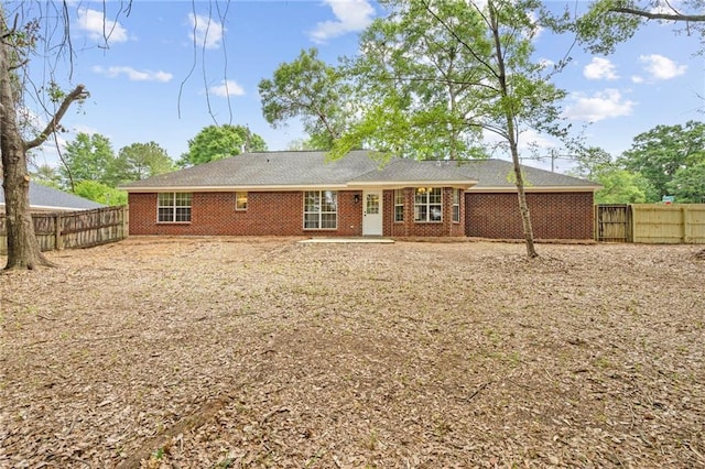 back of property featuring a fenced backyard