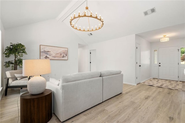 living area with baseboards, an inviting chandelier, visible vents, lofted ceiling with beams, and light wood-type flooring